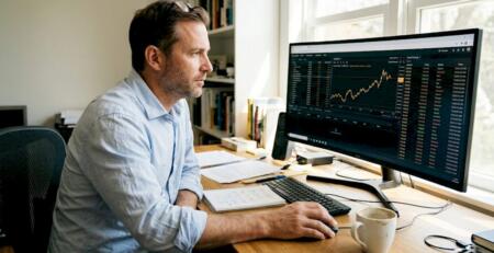 Trader monitors automated gold trading software