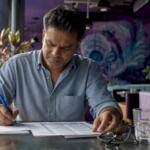 Man working with expert advisor documents at home