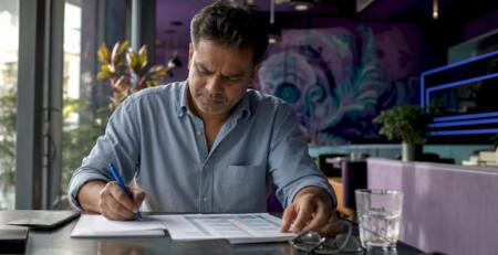 Man working with expert advisor documents at home