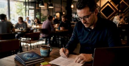 Trader reviewing prop firm checklist at desk